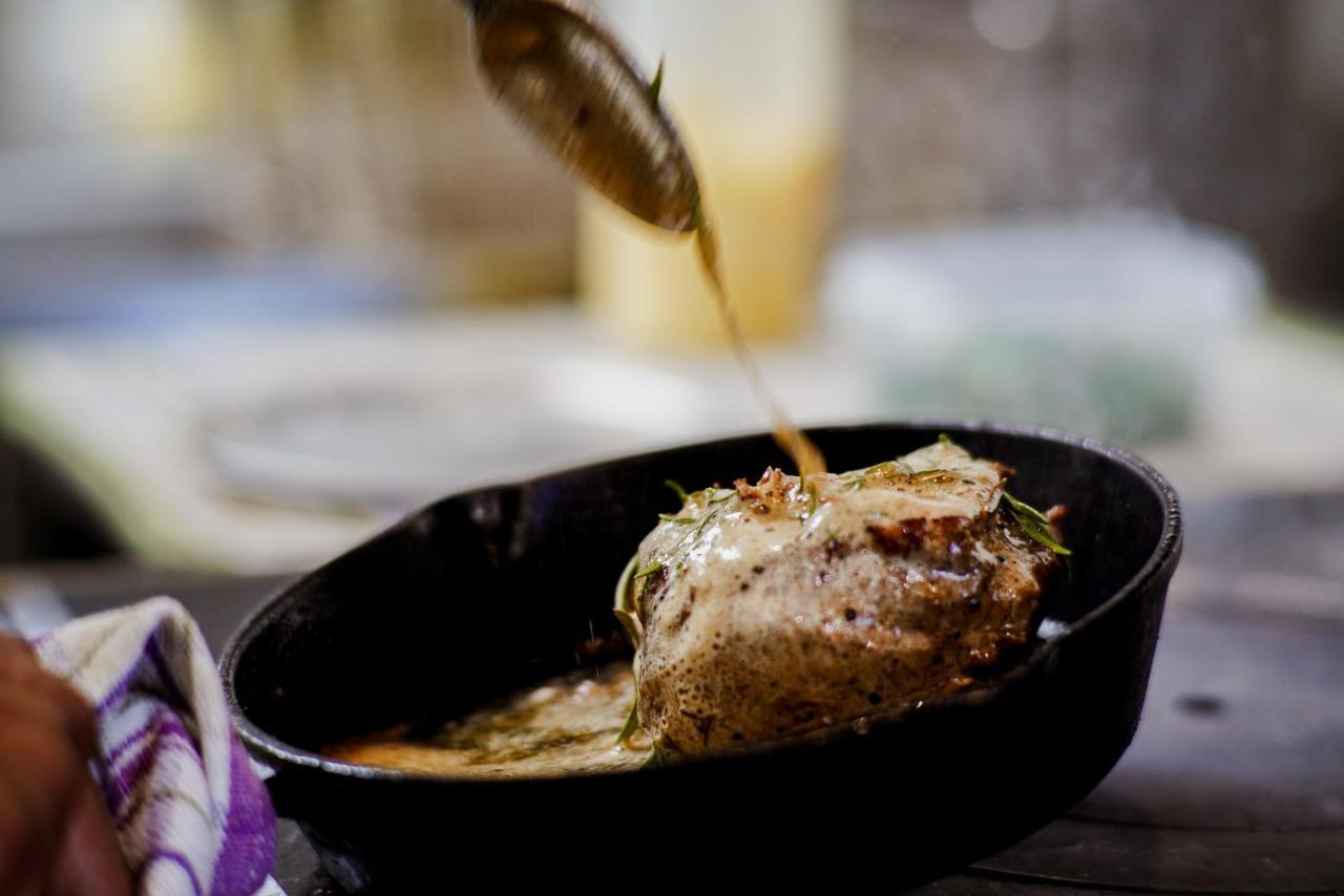 Parehua Resort Martinborough Extérieur photo A chef pouring sauce over a steak